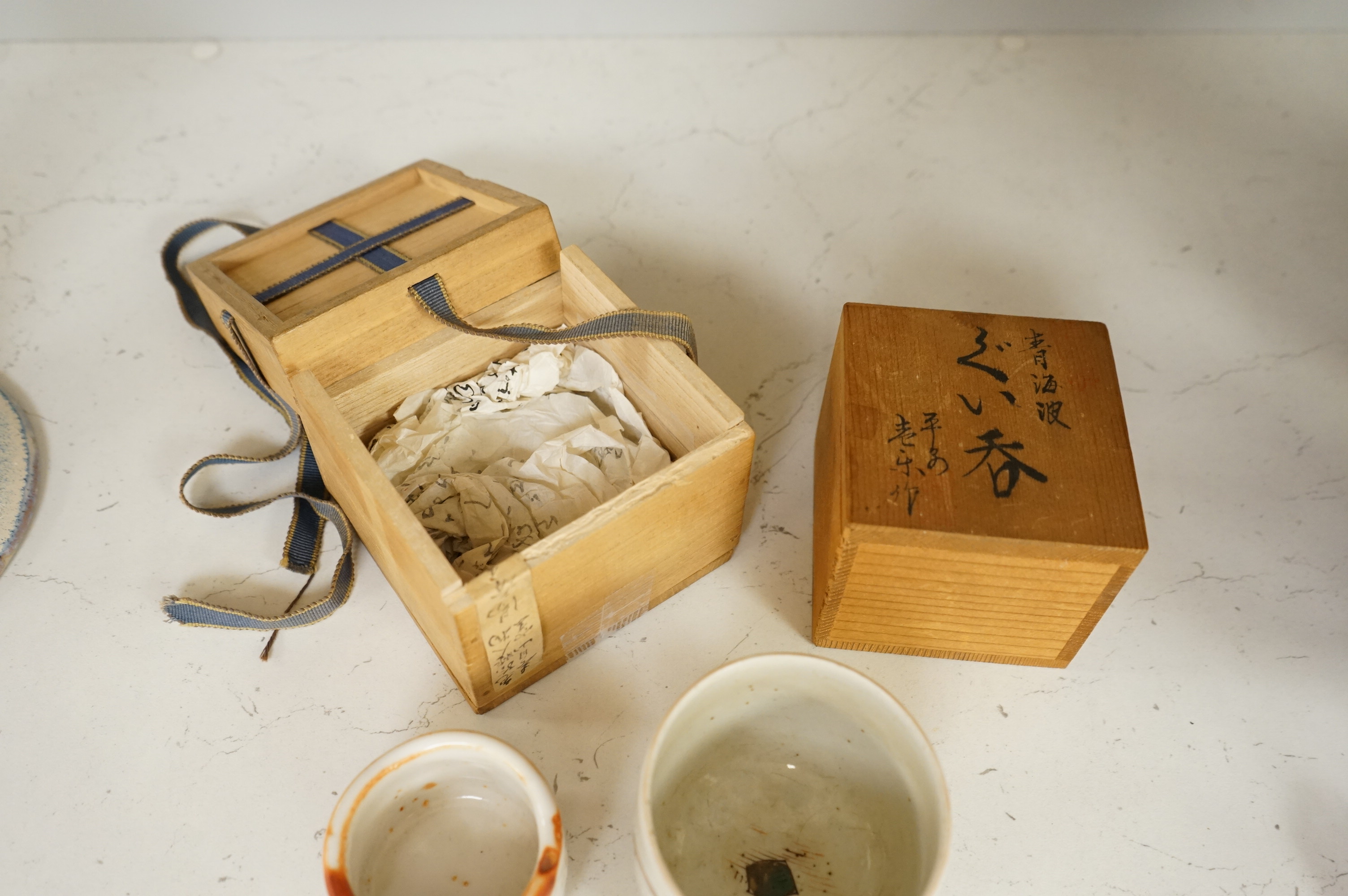 Two Japanese Mino ware sake cups, boxed, largest 7cm tall